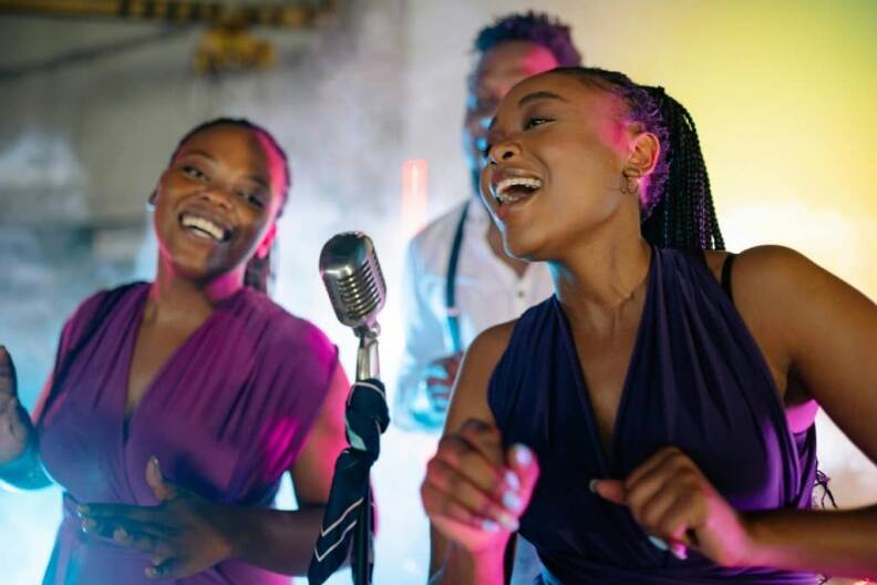 Friends singing popular karaoke hits 2025